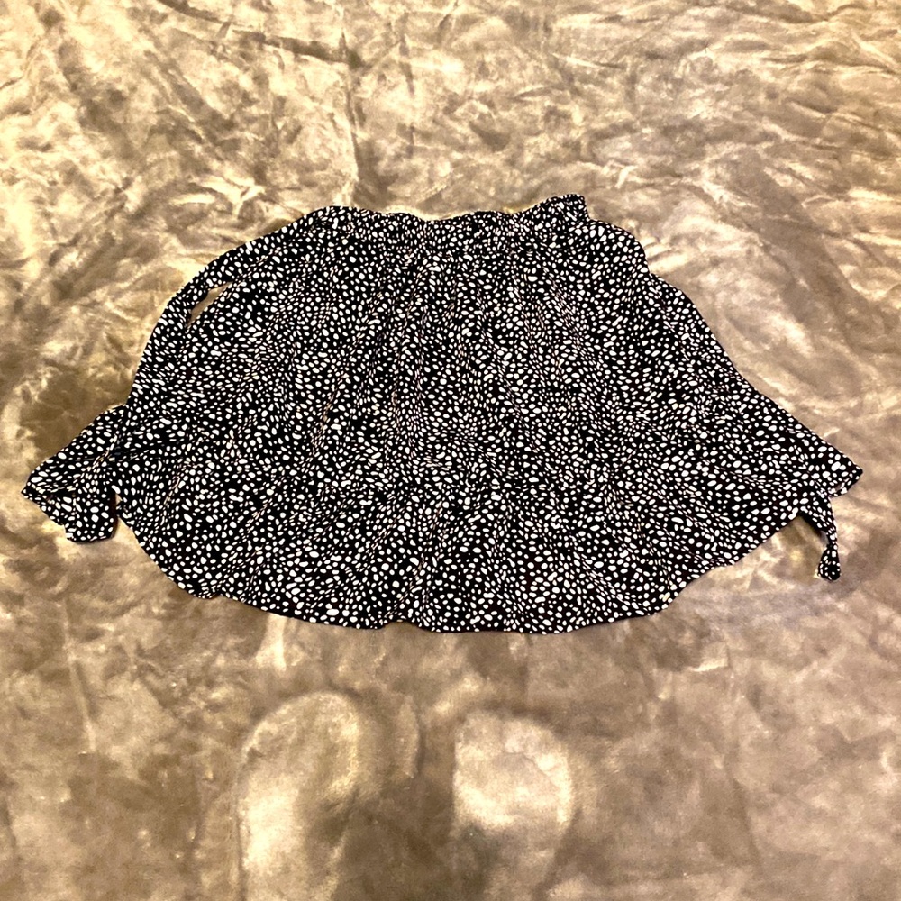 black polkadotted skirt with strings to tie a bow in the back